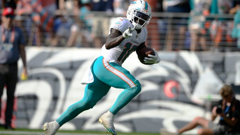 Miami Dolphins wide receiver Tyreek Hill (10) gestures as he runs for a touchdown during the second half of an NFL football game against the Baltimore Ravens. (Nick Wass/AP)