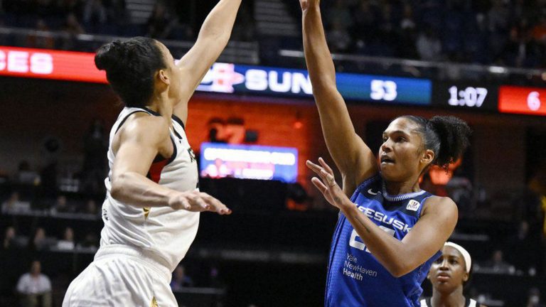 Connecticut Sun's Alyssa Thomas makes a basket over Las Vegas Aces' Kiah Stokes during the first half in Game 3 of basketball's WNBA Finals. (Jessica Hill/AP)