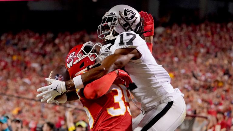 Las Vegas Raiders wide receiver Davante Adams (17) reaches for the ball in the end zone as Kansas City Chiefs cornerback Jaylen Watson, left, defends during the first half of an NFL football game Monday, Oct. 10, 2022, in Kansas City, Mo. Watson was charged with a pass interference penalty on the play. (Ed Zurga/AP Photo)