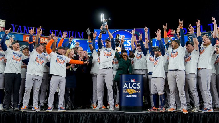 The Houston Astros celebrate with the American League Championship trophy after defeating the New York Yankees in Game 4 to win the American League Championship. (John Minchillo/AP)