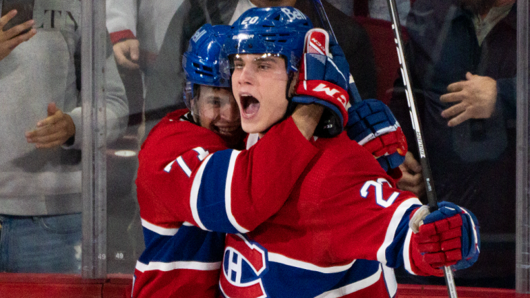 Montreal Canadiens' Juraj Slafkovsky celebrates his goal against the Arizona Coyotes with teammate Jake Evans during second period NHL hockey action in Montreal, on Thursday, October 20, 2022. (CP)