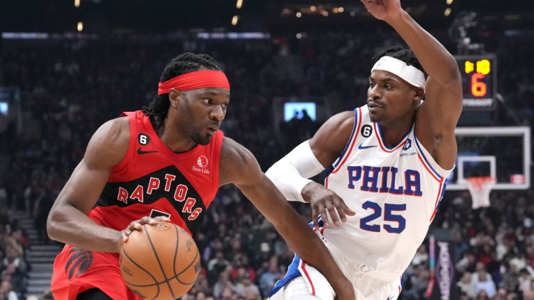 Toronto Raptors' Precious Achiuwa, left, drives at Philadelphia 76ers' Danuel House Jr. during first half NBA basketball action in Toronto on Friday, October 28, 2022. THE CANADIAN PRESS/Chris Young