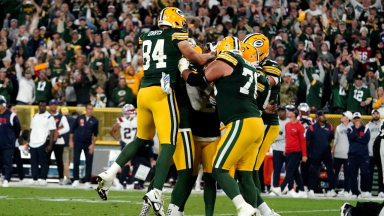 Green Bay Packers players celebrate with kicker Mason Crosby after his 31-yard field goal during overtime in an NFL football game against the New England Patriots, Sunday, Oct. 2, 2022, in Green Bay, Wis. The Packers won 27-24. (AP Photo/Morry Gash)