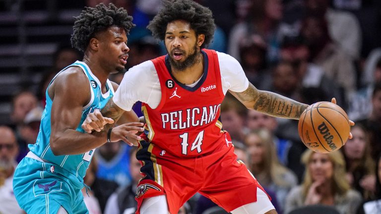 New Orleans Pelicans forward Brandon Ingram, right, works under pressure from Charlotte Hornets guard Dennis Smith Jr. during the second half of an NBA basketball game Friday, Oct. 21, 2022, in Charlotte, N.C. (Rusty Jones/AP)