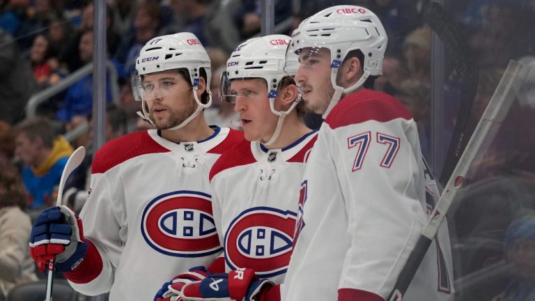 Montreal Canadiens' Christian Dvorak, center, is congratulated by teammates Josh Anderson, left, and Kirby Dach (77) after scoring during the third period of an NHL hockey game Saturday, Oct. 29, 2022, in St. Louis. (Jeff Roberson/AP)