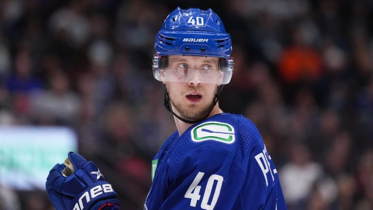 Vancouver Canucks' Elias Pettersson, of Sweden, lines up for a faceoff against the Buffalo Sabres during the third period of an NHL hockey game in Vancouver, on Saturday, October 22, 2022. (Darryl Dyck/CP)