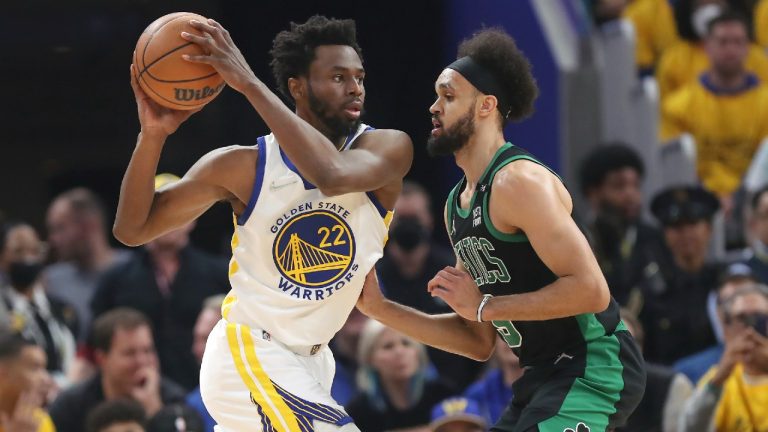 Golden State Warriors forward Andrew Wiggins (22) drives to the basket against Boston Celtics guard Derrick White during the first half of Game 5 of basketball's NBA Finals in San Francisco, Monday, June 13, 2022. (Jed Jacobsohn/AP)