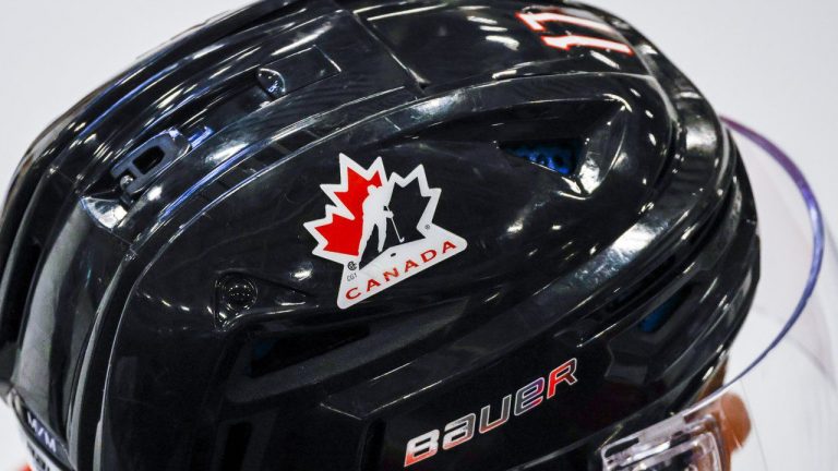 A Hockey Canada logo is visible on the helmet of a national junior team player during a training camp practice in Calgary, Tuesday, Aug. 2, 2022. (Jeff McIntosh/CP)