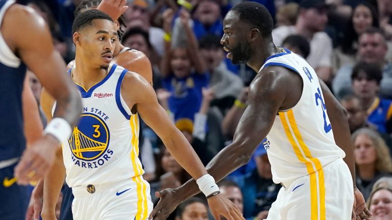 Golden State Warriors guard Jordan Poole (3) is congratulated by forward Draymond Green after scoring against the Denver Nuggets during the first half of an NBA preseason basketball game in San Francisco, Friday, Oct. 14, 2022. (Jeff Chiu/AP)