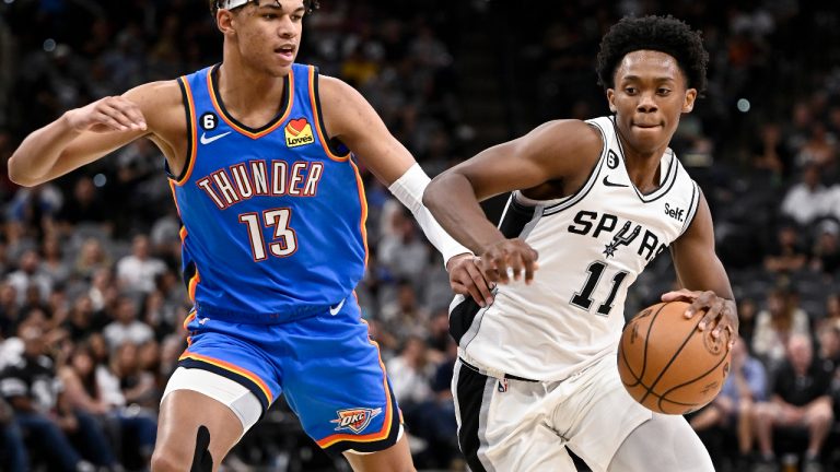 Thunder Spurs Basketball
San Antonio Spurs' Josh Primo (11) drives against Oklahoma City Thunder's Ousmane Dieng during the second half of a preseason NBA basketball game Thursday, Oct. 13, 2022, in San Antonio. Oklahoma City won 118-112. (Darren Abate/AP)