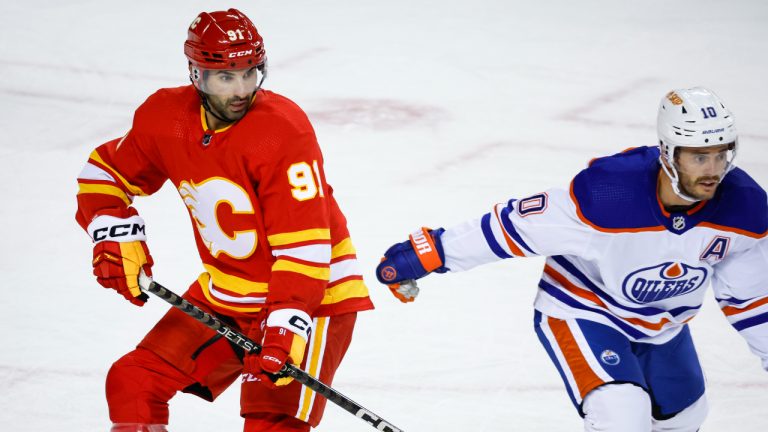 Edmonton Oilers forward Derek Ryan, right, and Calgary Flames centre Nazem Kadri follow the play during first period NHL preseason hockey action in Calgary. (Jeff McIntosh/CP)