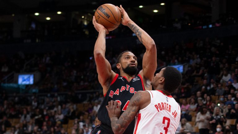 Toronto Raptors' Khem Birch (left) scores over Houston Rocket' Kevin Porter Jr. during first half NBA basketball action in Toronto on Friday, April 8, 2022. (Chris Young/CP)