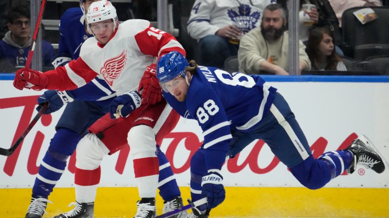 Toronto Maple Leafs right wing William Nylander (88) and Detroit Red Wings left wing Jakub Vrana (15) go after the puck during first period NHL hockey action in Toronto, Tuesday, April 26, 2022. (Frank Gunn/CP)