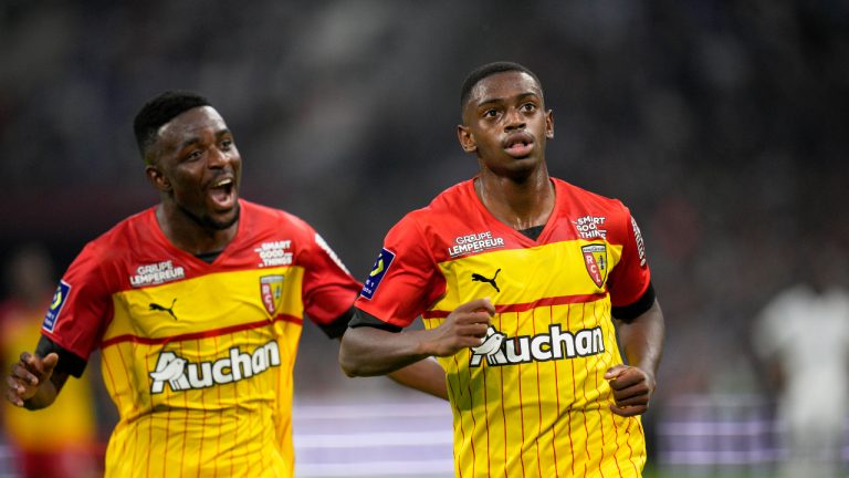 Lens' David Costa celebrates with teammate Salis Abdul Samed, left, after scoring the opening goal during the French League One soccer match between Marseille and Lens at the Velodrome stadium in Marseille, southern France, Saturday, Oct. 22, 2022. (Daniel Cole/AP)