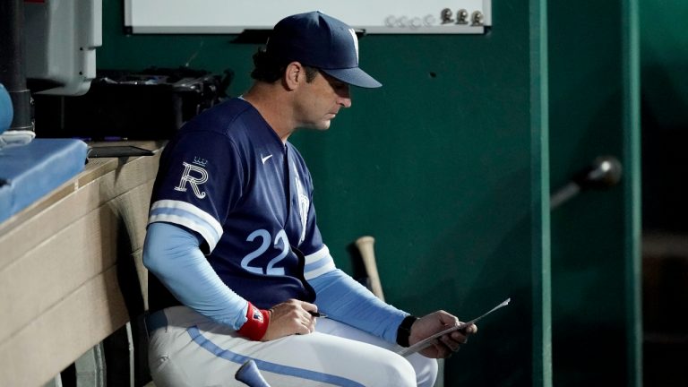 Kansas City Royals manager Mike Matheny looks at his notes in the dugout during the sixth inning of a baseball game against the Houston Astros Friday, June 3, 2022, in Kansas City, Mo. (Charlie Riedel/AP)