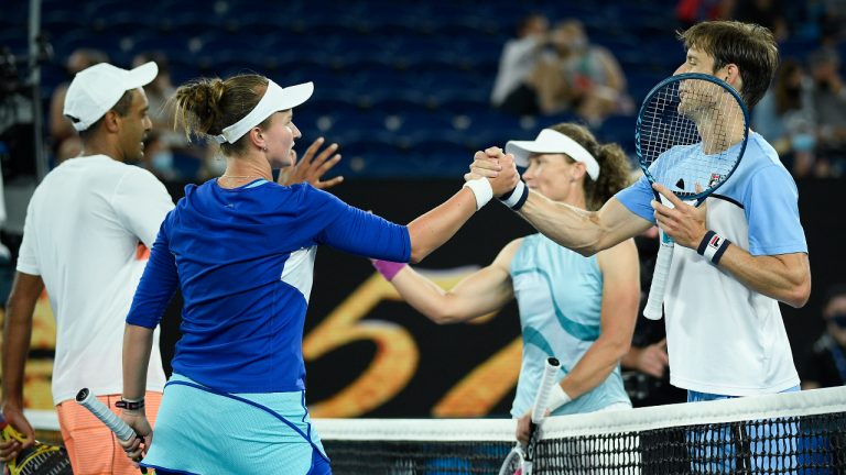 Rajeev Ram, left, of the US and Barbora Krejcikova of the Czech Republic are congratulated by Australia's Samantha Stosur and Matthew Ebden, right, after winning the mixed doubles final at the Australian Open tennis championship in Melbourne, Australia, Saturday, Feb. 20, 2021.(Andy Brownbill/AP)