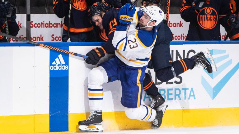 Buffalo Sabres' Mattias Samuelsson (23) checks Edmonton Oilers' Jesse Puljujarvi (13) during second period NHL action in Edmonton on Tuesday, October 18, 2022. (Jason Franson/CP)