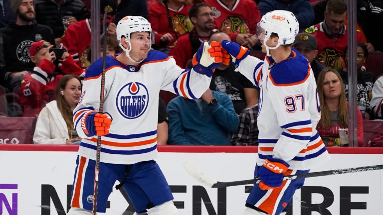 Edmonton Oilers left wing Zach Hyman, left, celebrates with center Connor McDavid after scoring his goal during the first period of an NHL hockey game. (Nam Y. Huh/AP)