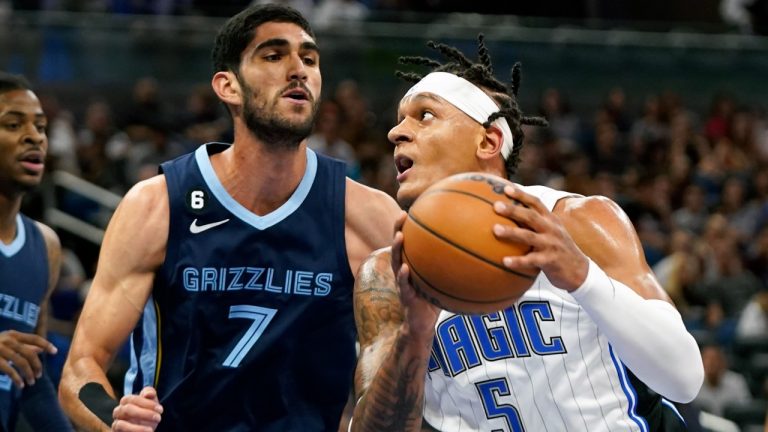 Orlando Magic's Paolo Banchero (5) looks for a shot against Memphis Grizzlies' Santi Aldama (7) during the first half of an NBA preseason basketball game Tuesday, Oct. 11, 2022, in Orlando, Fla. (John Raoux/AP)