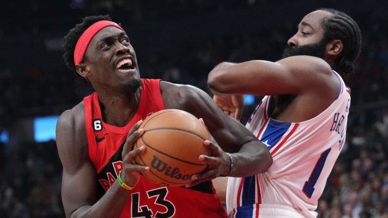 Toronto Raptors' Pascal Siakam, left, looks to shoot as Philadelphia 76ers' James Harden defends during first half NBA basketball action. (Chris Young/CP)