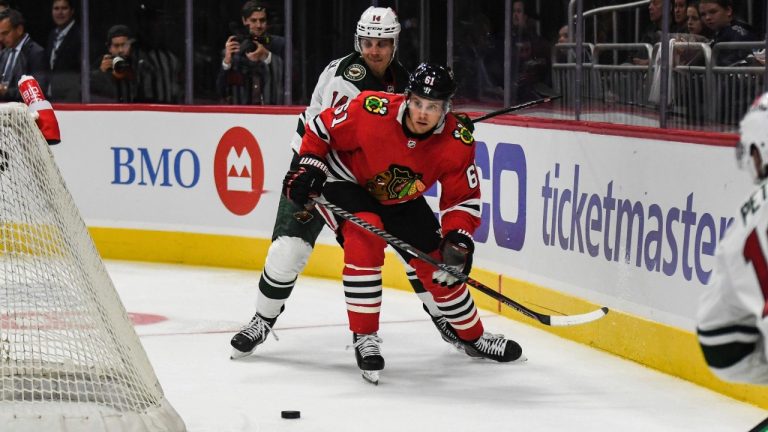 Chicago Blackhawks' Riley Stillman looks to clear the puck out of the Blackhawks zone during the third period of a preseason NHL hockey game against the Minnesota Wild, Sunday, Oct. 2, 2022, in Milwaukee. (Kenny Yoo/AP)