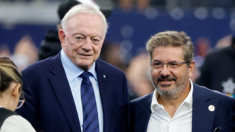 Dallas Cowboys team owner Jerry Jones and Dan Snyder, co-owner and co-CEO of the Washington Commanders, pose for a photo on the field during warmups before a NFL football game. (Michael Ainsworth/AP)