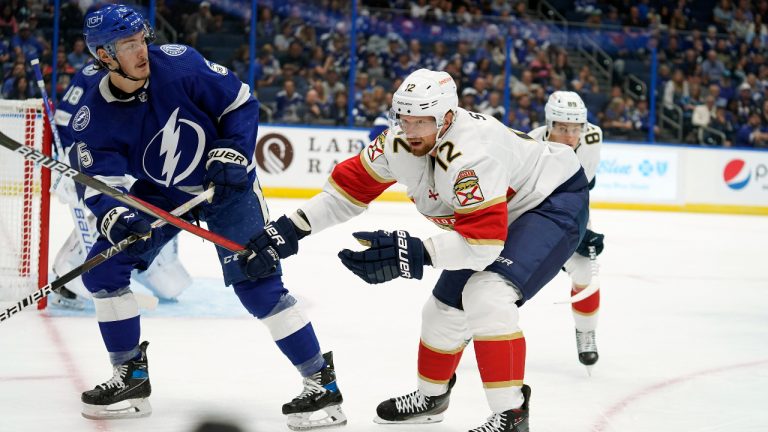 Florida Panthers center Eric Staal (12) deflects the puck away from Tampa Bay Lightning defenseman Philippe Myers (5) during the first period of an NHL preseason hockey game Saturday, Oct. 8, 2022, in Tampa, Fla. (Chris O'Meara/AP)