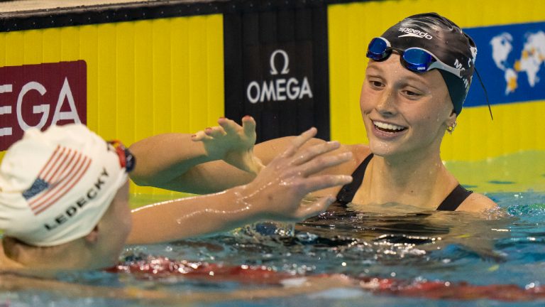 Summer McIntosh of Canada is congratulated by Katie Ledecky of the USA after winning the women’s 400m freestyle in World Junior Record time at the FINA Swimming World Cup meet in Toronto on Friday, October 28, 2022. (CP)