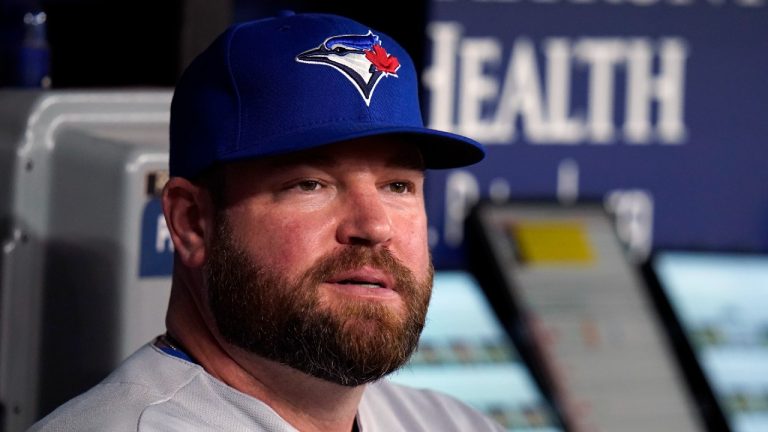 FILE - Toronto Blue Jays interim manager John Schneider looks on from the dugout during the first inning of a baseball game against the Tampa Bay Rays, Thursday, Sept. 22, 2022, in St. Petersburg, Fla. The Blue Jays rewarded Schneider for his strong performance as their interim manager, agreeing to terms with him Friday, Oct. 21, 2022, on a new contract. Schneider agreed to a three-year deal as manager with a team option for 2026, the Blue Jays said. (Chris O'Meara/AP)