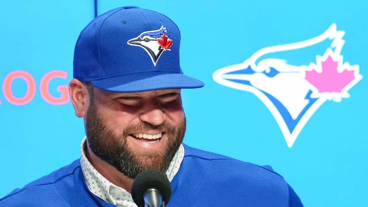 Toronto Blue Jays manager John Schneider, right, laughs as he