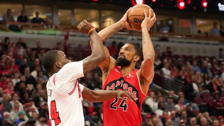 Toronto Raptors' Khem Birch, right, shoots over Chicago Bulls' Javonte Green during the first half of an NBA basketball game Monday, March 21, 2022, in Chicago. (Charles Rex Arbogast/AP)