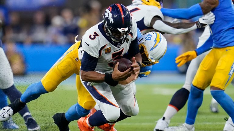 Los Angeles Chargers linebacker Drue Tranquill (49) sacks Denver Broncos quarterback Russell Wilson (3) during the second half of an NFL football game, Monday, Oct. 17, 2022, in Inglewood, Calif. (Marcio Jose Sanchez/AP Photo)