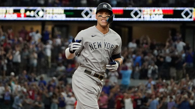 New York Yankees' Aaron Judge gestures as he rounds the bases after hitting a solo home run, his 62nd of the season, during the first inning in the second baseball game of a doubleheader against the Texas Rangers in Arlington, Texas, Tuesday, Oct. 4, 2022. With the home run, Judge set the AL record for home runs in a season, passing Roger Maris.(LM Otero/AP)