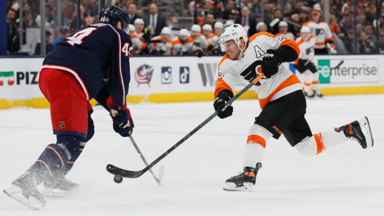 Philadelphia Flyers' Cam Atkinson, right, shoots the puck as Columbus Blue Jackets' Vladislav Gavrikov defends during the first period of an NHL hockey game Thursday, April 7, 2022, in Columbus, Ohio. (Jay LaPrete/AP)