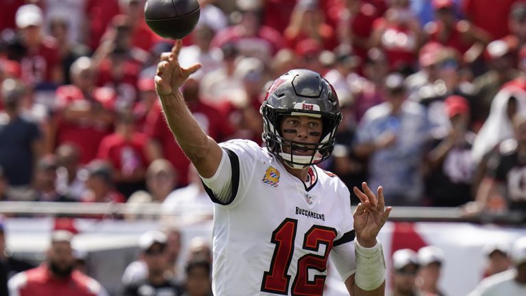 Tampa Bay Buccaneers quarterback Tom Brady (12) throws a touchdown pass to running back Leonard Fournette during the second half of an NFL football game against the Atlanta Falcons Sunday, Oct. 9, 2022, in Tampa, Fla. (Chris O'Meara/AP)