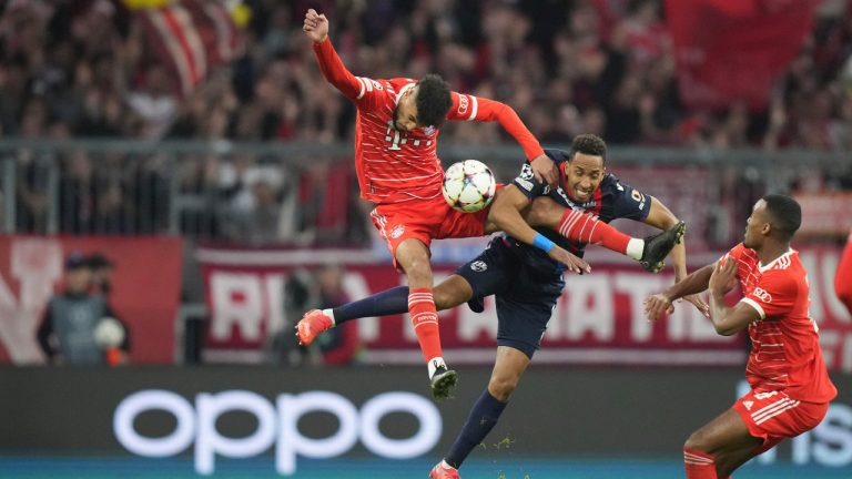 Bayern's Noussair Mazraoui, left, and Plzen's Jhon Mosquera jump for the ball during the Champions League group C soccer match between Bayern Munich and Viktoria Plzen in Munich, Germany, Tuesday, Oct. 4, 2022. (Matthias Schrader/CP) 