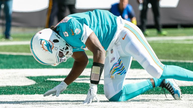 Miami Dolphins quarterback Teddy Bridgewater (5) is knocked down on the Dolphins first offensive play of an NFL game against the New York Jets on Sunday, Oct. 9, 2022