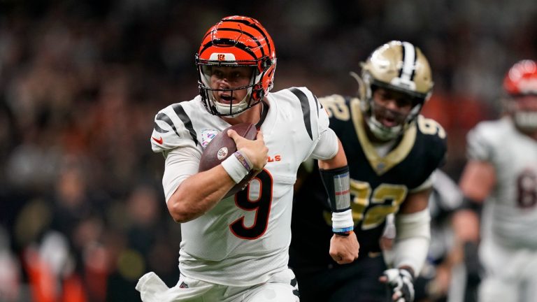 Cincinnati Bengals quarterback Joe Burrow (9) runs for a touchdown against the New Orleans Saints' Marcus Davenport (92) during the first half of an NFL football game in New Orleans, Sunday, Oct. 16, 2022. (Gerald Herbert/AP)