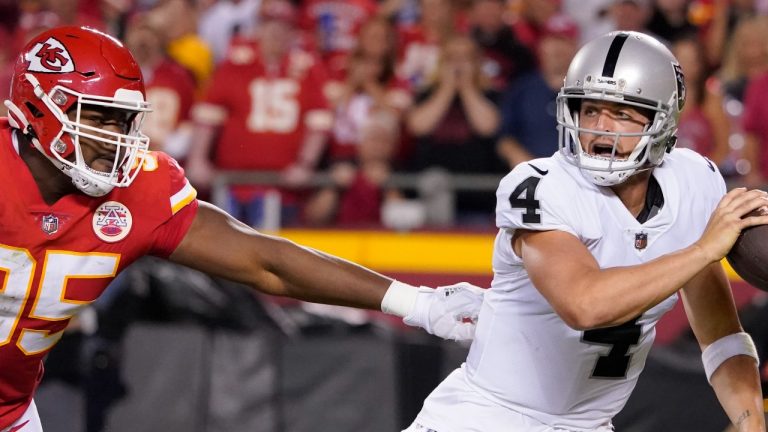 Las Vegas Raiders quarterback Derek Carr (4) scrambles away from Kansas City Chiefs defensive tackle Chris Jones (95) during the second half of an NFL football game Monday, Oct. 10, 2022, in Kansas City, Mo. (AP Photo/Ed Zurga)