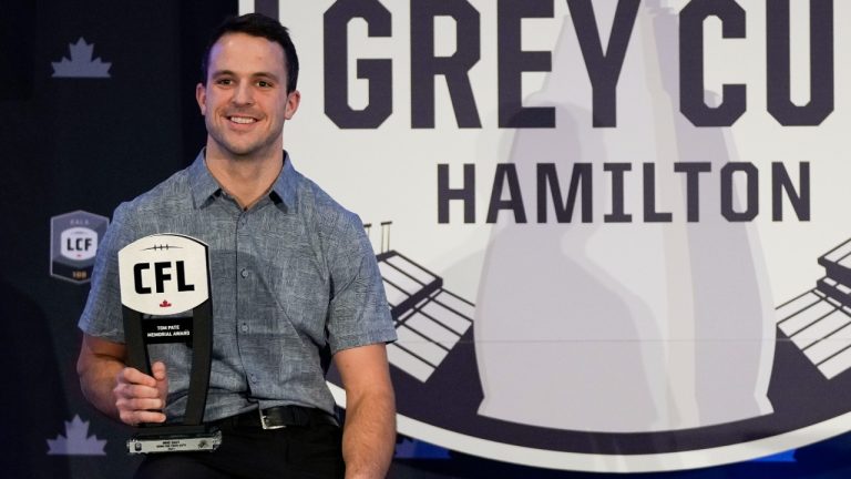 Hamilton Tiger Cats' Mike Daly is awarded the Tom Pate Award during the CFL Awards in Hamilton, Ont., on Friday, Dec. 10, 2021. (Nathan Denette/CP)