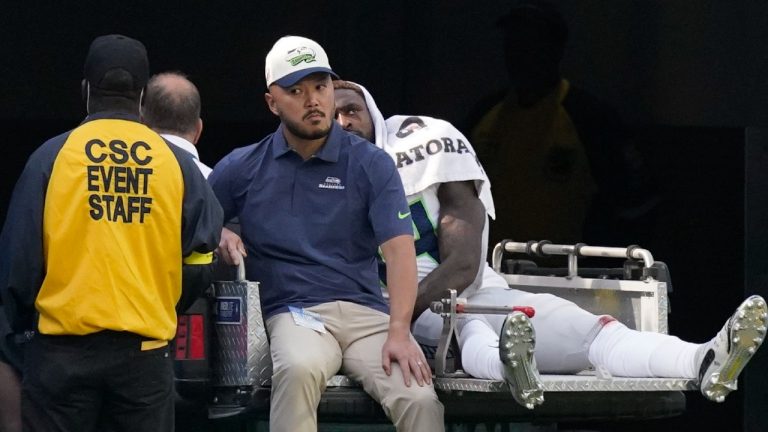 Seattle Seahawks wide receiver DK Metcalf (14) leaves the field with an injury during the first half of an NFL football game against the Los Angeles Chargers Sunday, Oct. 23, 2022, in Inglewood, Calif. (AP Photo/Mark J. Terrill)