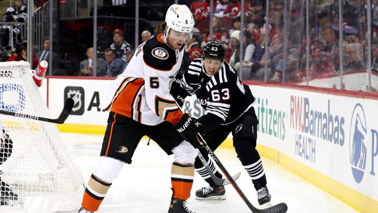 Anaheim Ducks defenceman Jamie Drysdale (6) plays the puck next to New Jersey Devils left wing Jesper Bratt (63) during the second period of an NHL hockey game. (Noah K. Murray/AP)