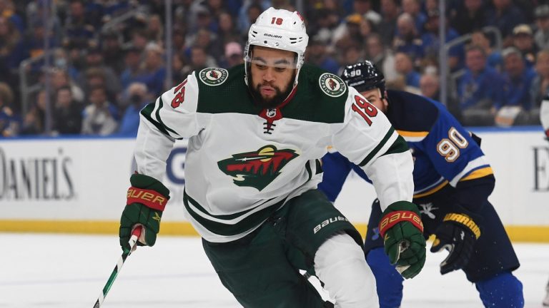 Minnesota Wild's Jordan Greenway (18) advances the puck during the first period in Game 4 of an NHL hockey Stanley Cup first-round playoff series against the St. Louis Blues, Sunday, May 8, 2022, in St. Louis. (AP Photo/Michael Thomas)