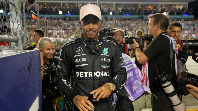 Mercedes driver Lewis Hamilton of Britain walks after clocking the third fastest time during the qualifying session at the Singapore Formula One Grand Prix, at the Marina Bay City Circuit in Singapore, Saturday, Oct. 1, 2022. (Vincent Thian/AP)