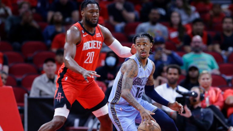 Memphis Grizzlies guard Ja Morant (12) looks to drive around Houston Rockets forward Bruno Fernando (20) during the first half of an NBA basketball game Friday, Oct. 21, 2022, in Houston. (Michael Wyke/AP)