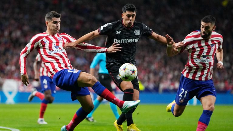 Atletico Madrid's Alvaro Morata, left, and Yannick Carrasco, right, challenge for the ball with Leverkusen's Nadiem Amiri during the group B Champions League soccer match between Atletico Madrid and Bayer 04 Leverkusen at the Civitas Metropolitano stadium in Madrid, Spain, Wednesday, Oct. 26, 2022. (Manu Fernaandez/AP)