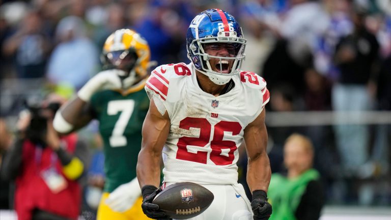 New York Giants running back Saquon Barkley (26) celebrates a touchdown during the second half of an NFL football game against the Green Bay Packers at the Tottenham Hotspur stadium. (Alastair Grant/AP)