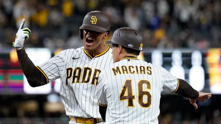 San Diego Padres' Juan Soto, left, reacts after hitting an RBI single during the seventh inning in Game 4 of a baseball NL Division Series against the Los Angeles Dodgers, Saturday, Oct. 15, 2022, in San Diego. (Ashley Landis/AP Photo)