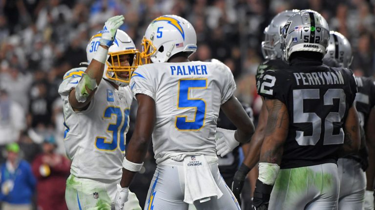 Los Angeles Chargers running back Austin Ekeler (30) celebrates after wide receiver Josh Palmer (5) scored a touchdown against the Las Vegas Raiders during the second half of an NFL football game. (David Becker/AP)