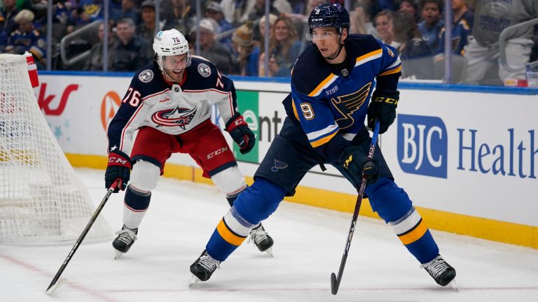 St. Louis Blues' Tyler Pitlick controls the puck as Columbus Blue Jackets' Owen Sillinger (76) defends during the second period of a preseason NHL hockey game Thursday, Sept. 29, 2022, in St. Louis. (Jeff Roberson/AP) 